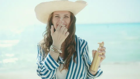Smiling woman enjoying a sunny day at the beach
